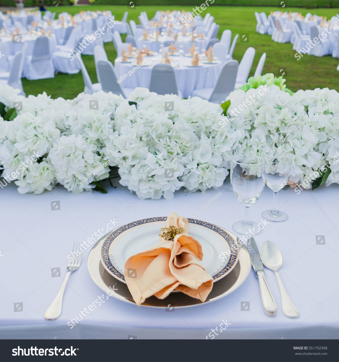 stock-photo-table-set-for-wedding-or-event-party-elegant-and-luxury-decoration-in-soft-orange-with-flowers-551792998.jpg