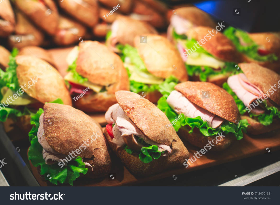 stock-photo-beautifully-decorated-catering-banquet-table-with-different-food-snacks-and-appetizers-with-742470133.jpg